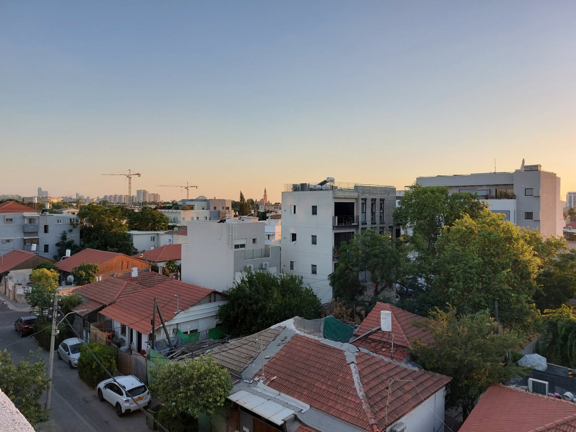 Red-tiled rooftops of Shapira at sunset